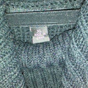 A knitted black dress with leather straps on the s